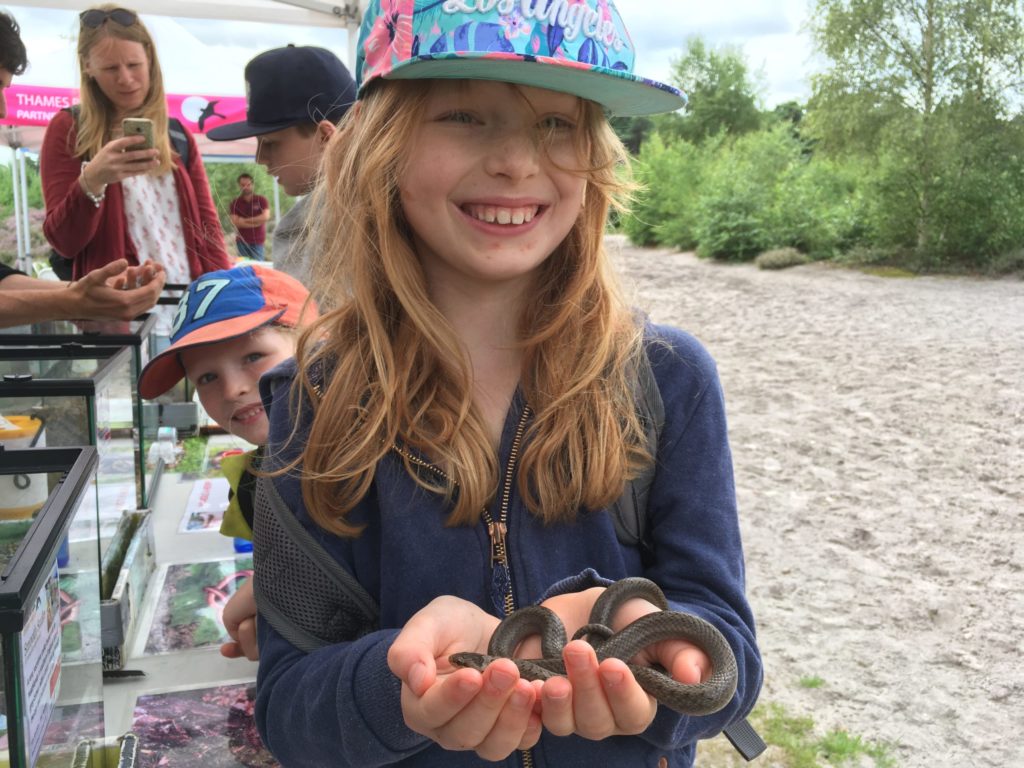 Photograph of a girl holding a snake