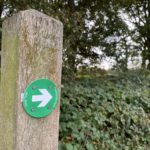 Waymarking is a white arrow on a green disk