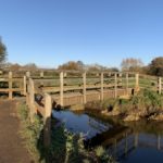 Photo of a wooden bridge over a small river