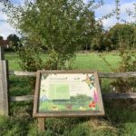 Photograph of the orchard and the sign that explains the rare varieties of fruit tress it has been planted with