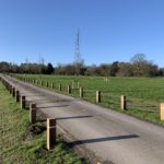 Photo of a farm track lined with wooden bollards