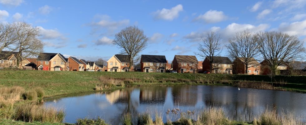 Photo of a large pond with housing around the perimeter