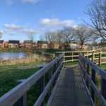 Photo of a bridge near a large pond