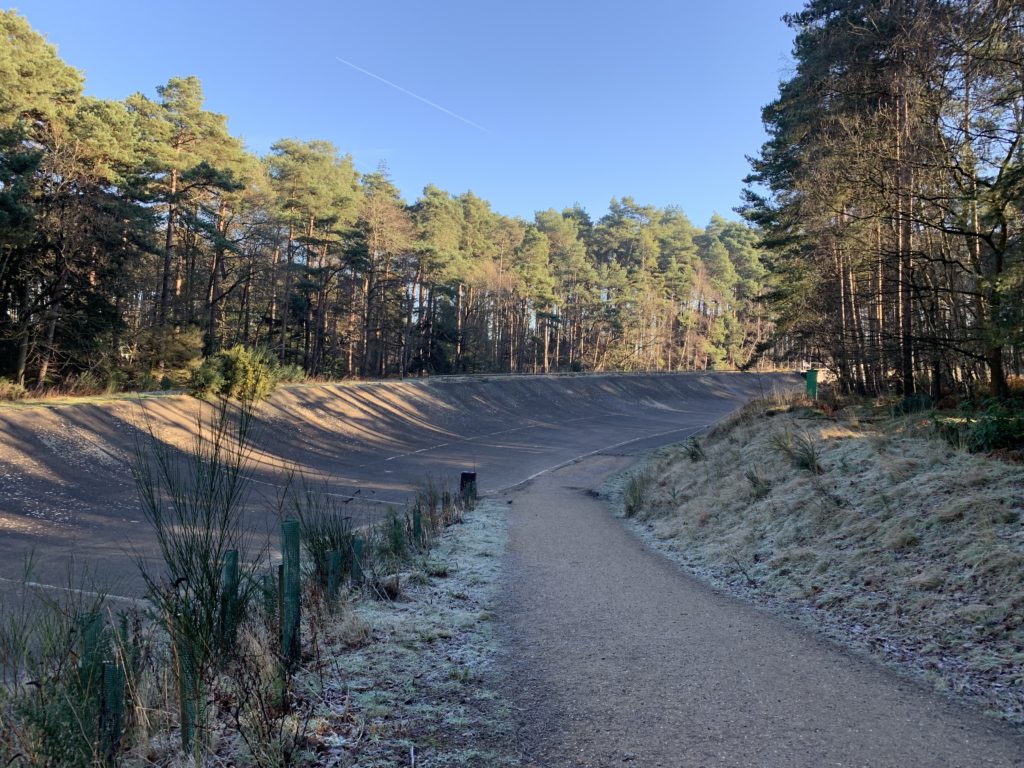 Photo of a banked concrete race track on a frosty morning