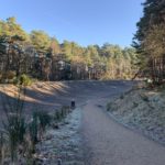 Photo of a banked concrete race track on a frosty morning