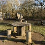 Photo of a play area featuring equipment made from old wooden reels and logs