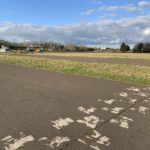 Photo of large open space, with tarmac track