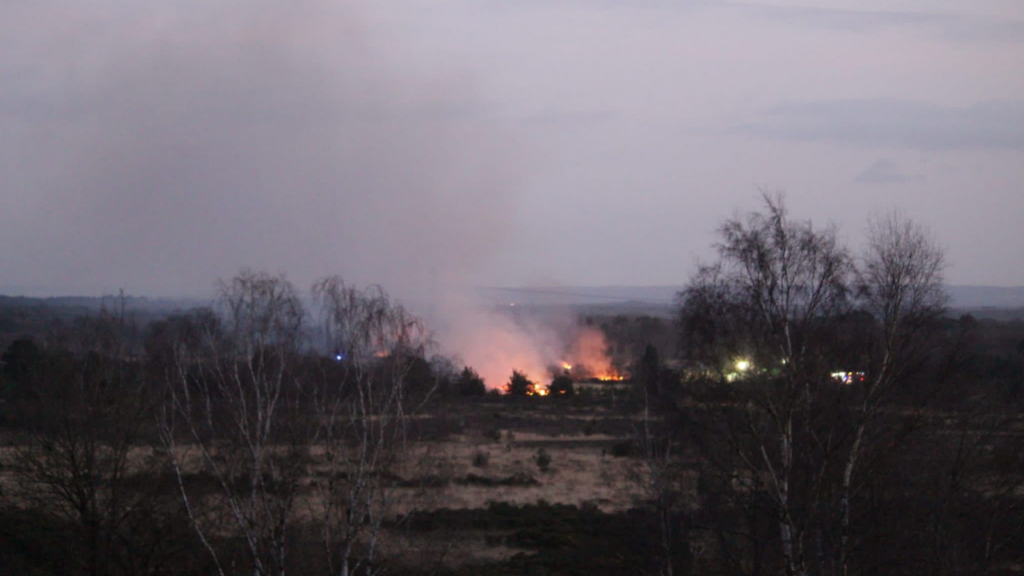 Photo taken at dusk, with the distant flames burning