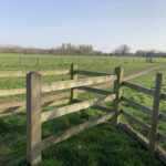 Photo of a gateway into a flat meadow