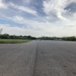 Photograph of a wide expense of tarmac, once part of the historic runway