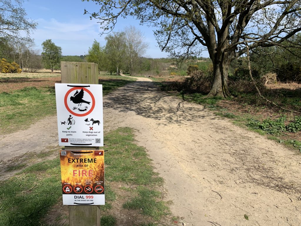 Signs asking people to keep to paths and to be aware of the fire risk