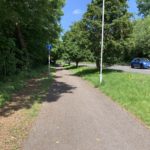 Photo of a cycle lane / footpath, alongside a road.