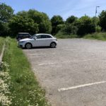 Photo of a medium sized, level car park.