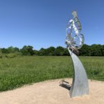 Photo of a steel sculpture depicting a butterfly resting on a plinth.