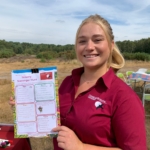 Photo of Warden Zoe holding up the scavenger hunt worksheet.