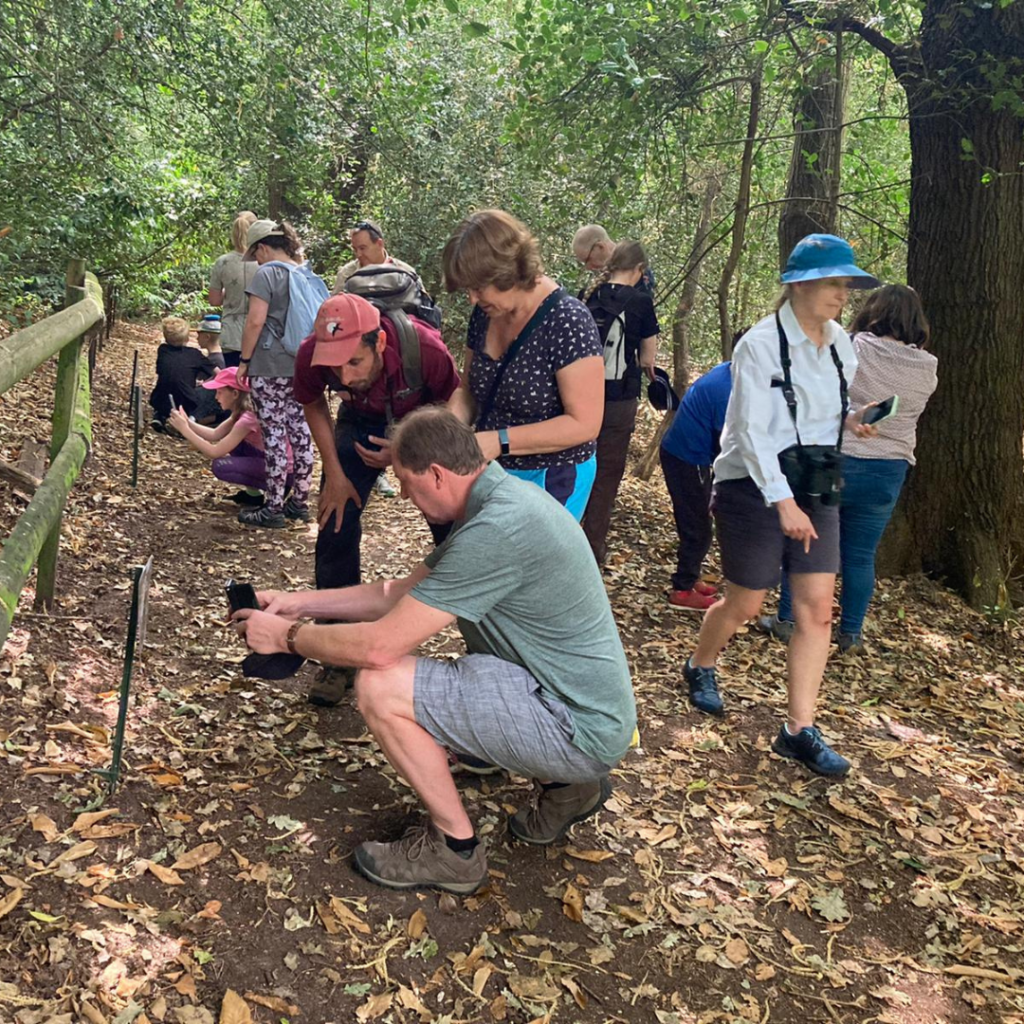 Photo of a group getting involved with Michael's activity to learn to use their phones.