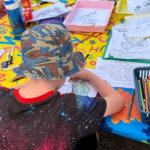 Photo of a young child colouring in a picture of a reptile