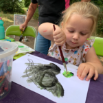 Photo of a little girl painting.