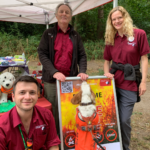 Photo of Wardens Tim, Mike and Ruth, and Monty the dog jumping up.