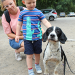 Photo of a mum and her child stroking Chester, the dog.