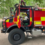 Children in a large off-road fire vehicle.