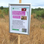 Photo of a smart information sign with information about Woodlark and Dartford Warbler