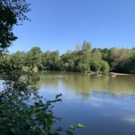 Photo of a nice view of the lake with blue sky behind.