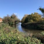 Photo of an attractive view down the River Wey to a cottage beside Stoke Lock