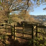Photo of wooden gateway looking out over countryside.
