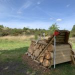 Photo of a wooden horse jump, with heathland in the background