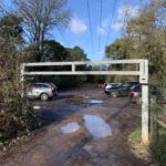 Photo of the entrance to the car park, with its height barrier