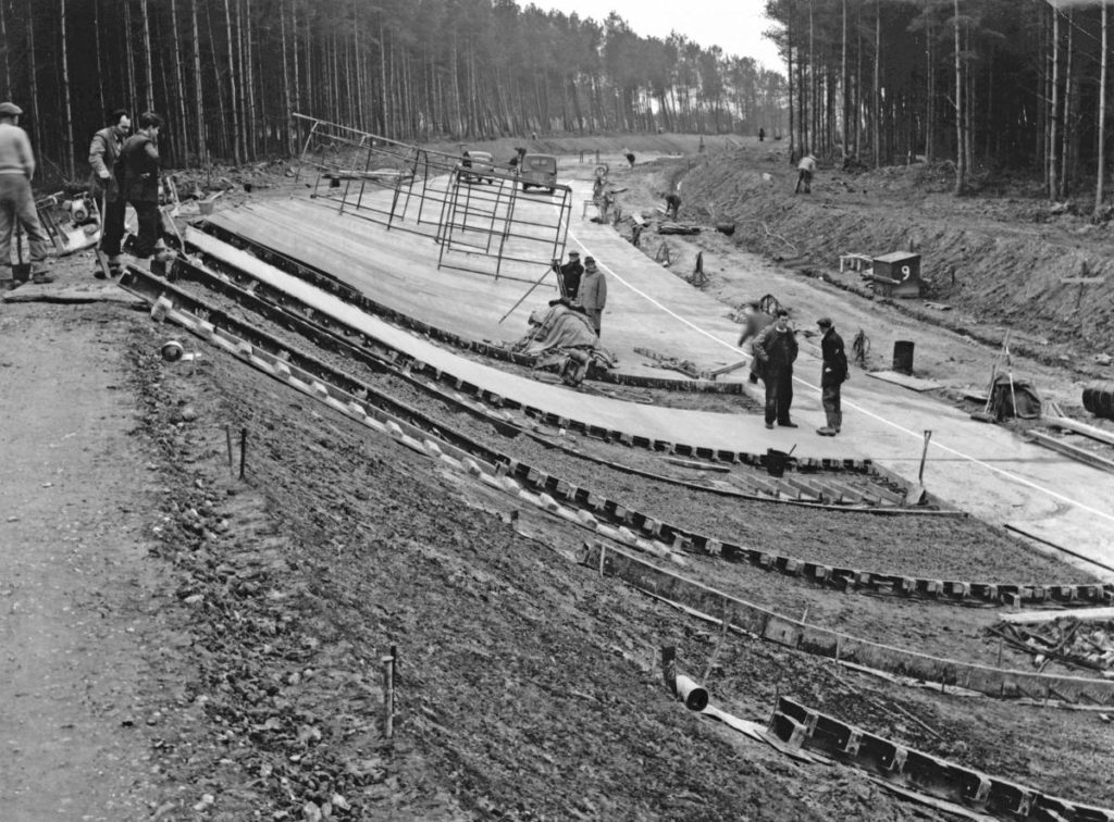 Old black & White photo of the banked test track under construction.