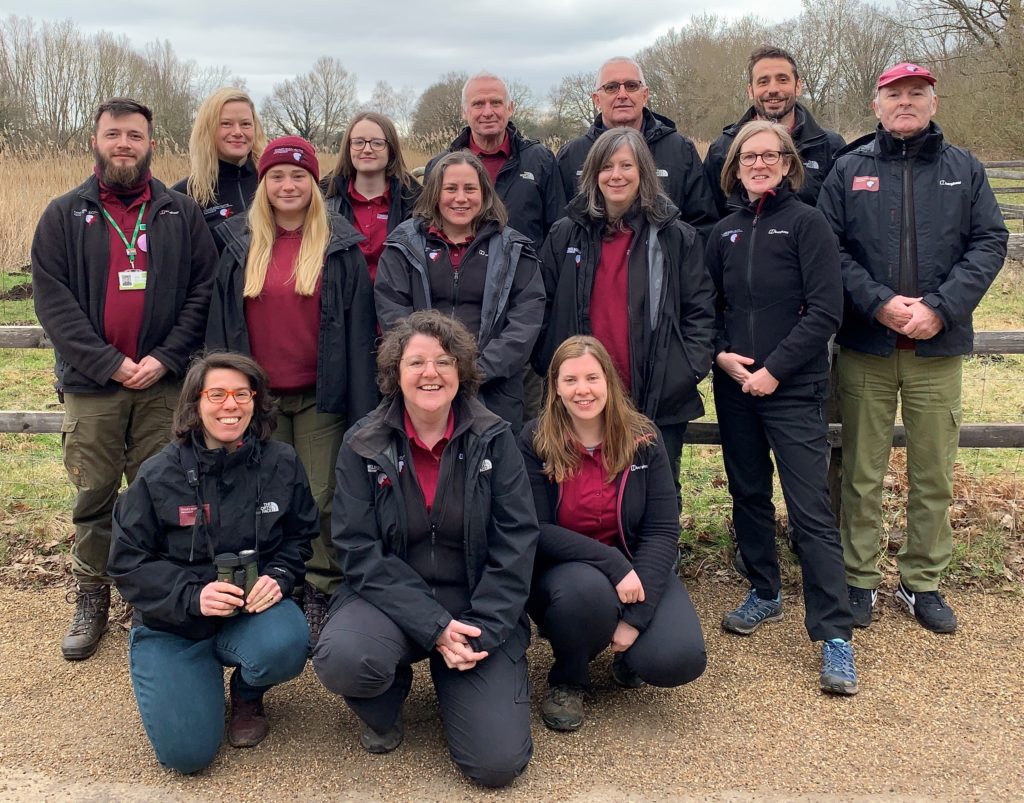 Photo of 14 team members in there Thames Basin Heaths uniforms - burgundy shirts and black jackets.