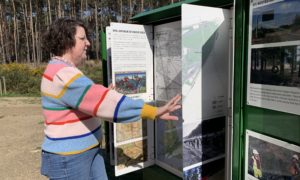 Photo of a person reading about site history in the mini museum.