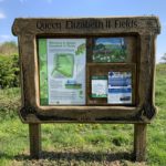 Photo of the noticeboard at Queen Elizabeth II Fields. Map of the walk and local information.