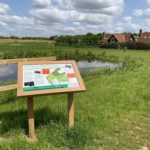 Photo of a sign with a map and information about the wildlife - bats and Skylarks.