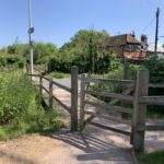 Photo of a wooden gateway that takes you to the road. On the opposite side is Langley Mead.