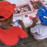 Photo of two little boys doing colouring.