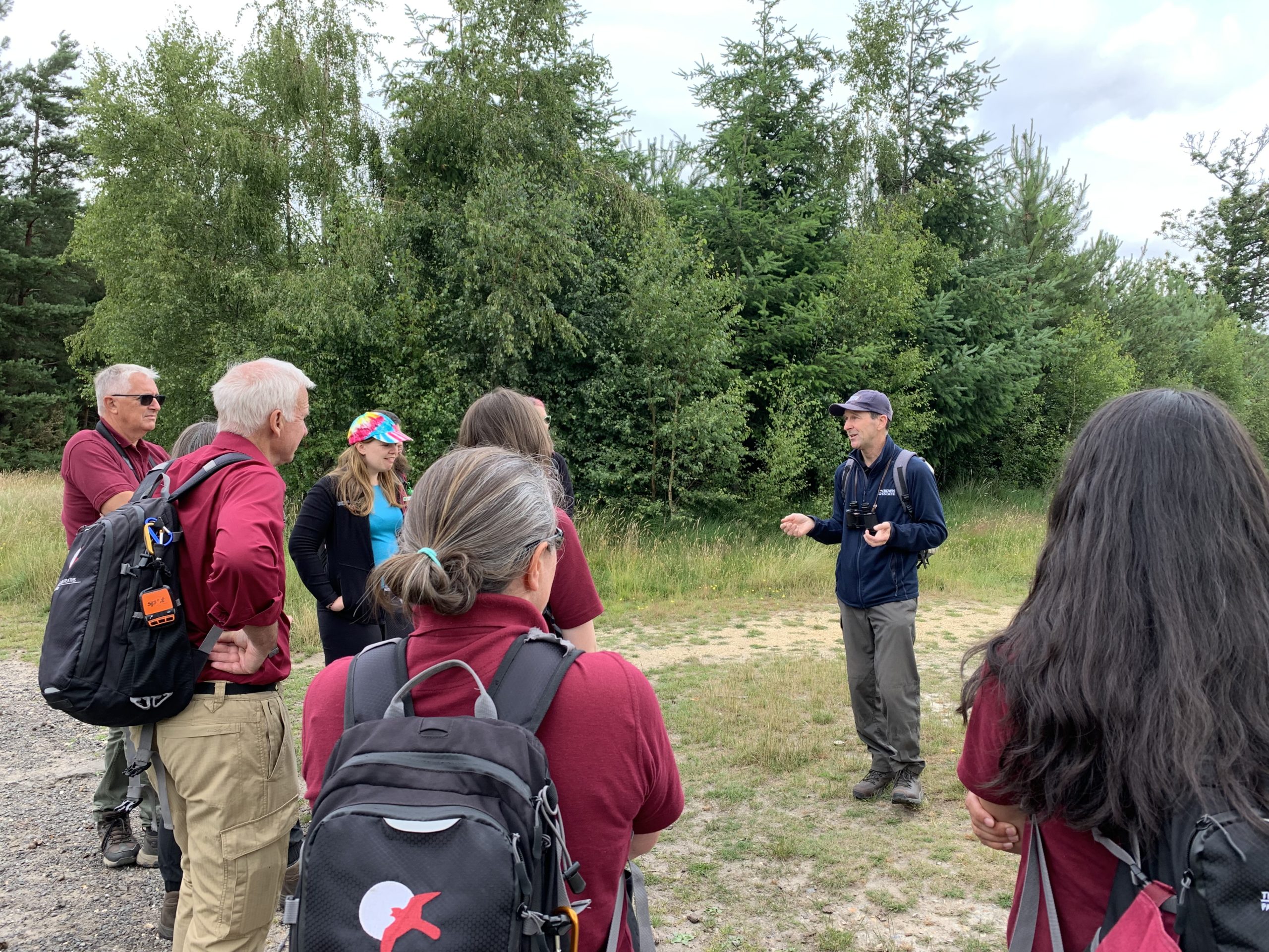 Photo of a group of wardens in their burgundy shirts, talking with the Crown Estate's Biodiversity & Conservation Manager