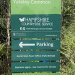 Photo of a large welcoming you to Yateley Common. The bottom part of the sign says "Ground Nesting Birds - Please keep dogs on paths and under close control - 1st March - 15th September".