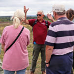 Photo of Warden Steve talking to a group of people. He waves his arms enthusiastically.