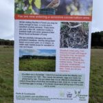 A photo of a sign explaining that "You are now entering a sensitive conservation area". It explains that the Woodlark is a rare bird in the UK and that Bracknell Forest Council are manging the area for Woodlark to nest and breed,