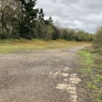 Photo of a banked section of concrete track, now mossy.