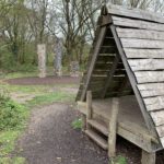 Photo of a play area featuring wooden 'houses' and climbing equipment.